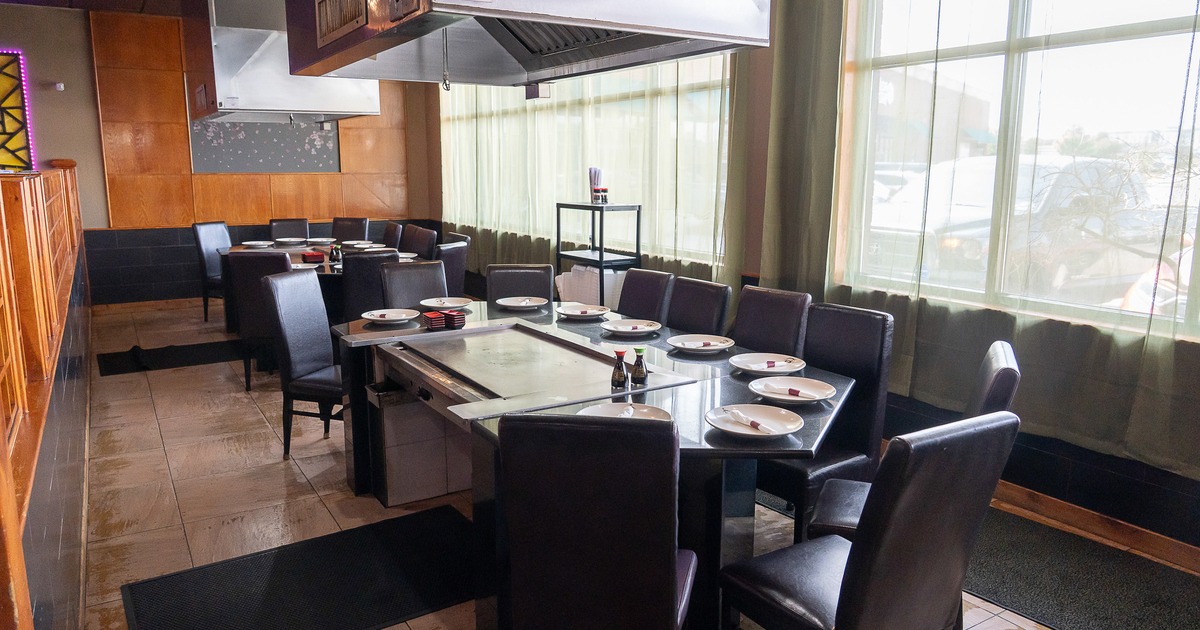 Japanese hibachi style interior dining area with two large teppanyaki grill tables