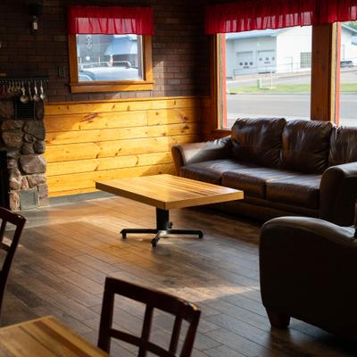 Leather sofa by a window and a wooden coffee table in a sunlit room.