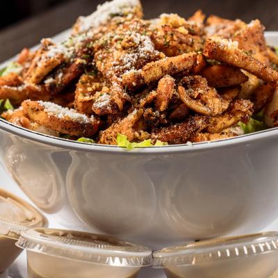 Paisano's World Famous Chicken Caesar Salad with Caesar dressing on the side.