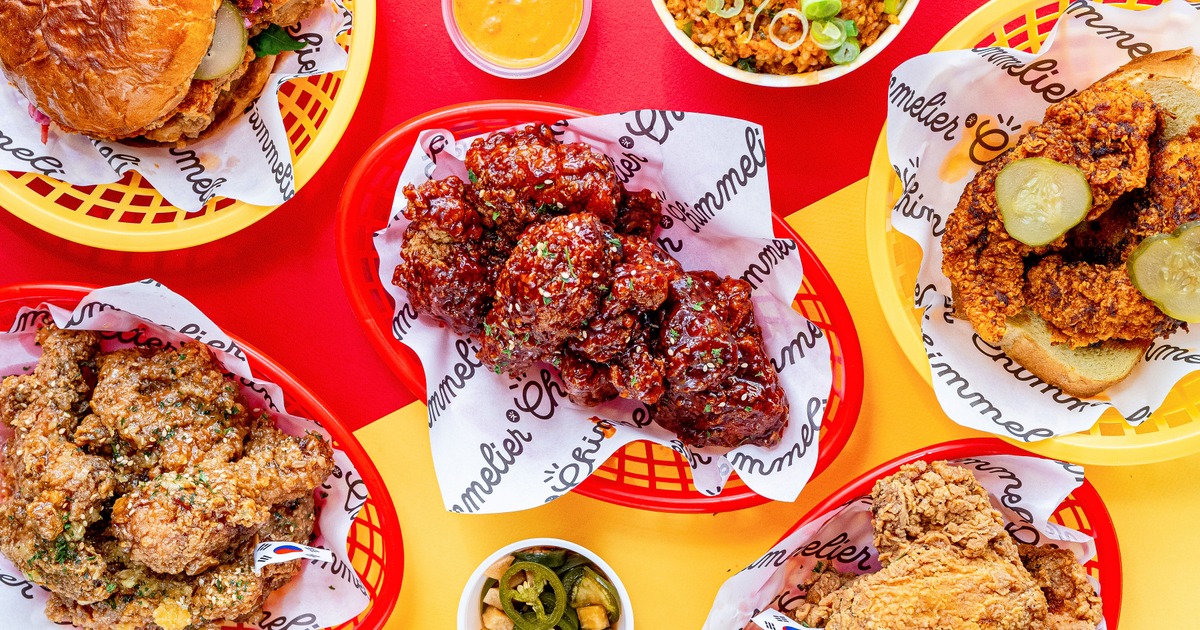 Basket of fried chicken served on the table beside other dishes