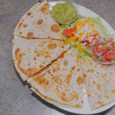 Chicken Quesadillas, served with salad, and guacamole.