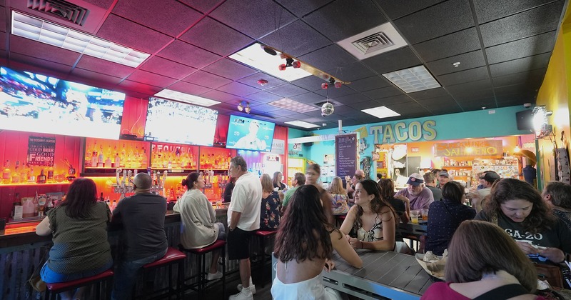 Interior, seating and bar area full of guests