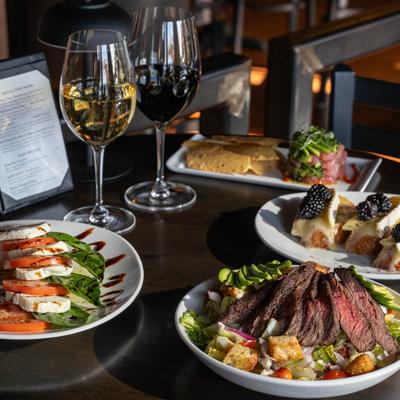 Assorted dishes and glasses of wine on a table.