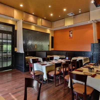 Interior dining room, booth seating and set tables ready for service.