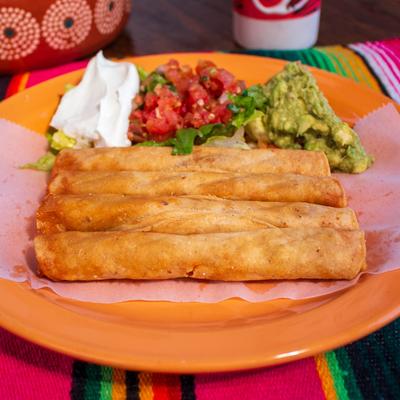 Chicken Taquitos, with lettuce, sour cream, guacamole, and salsa.