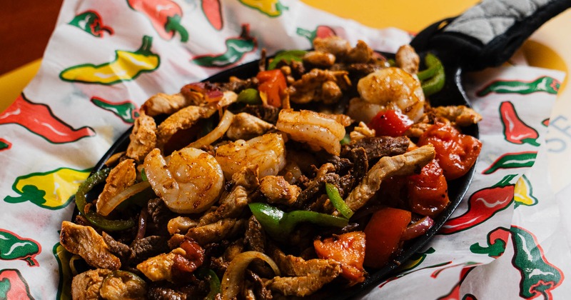 A skillet with mixed fajitas