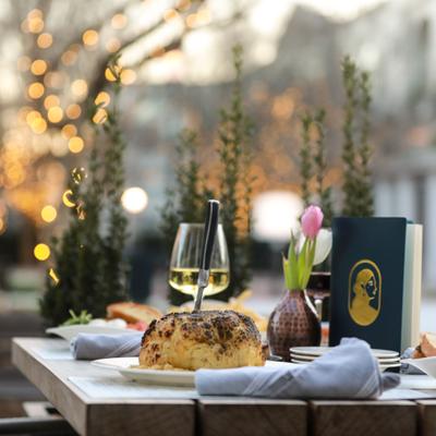 Dining table with a roasted cauliflower and wine