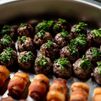 Meatballs with parsley and bacon-wrapped bites.
