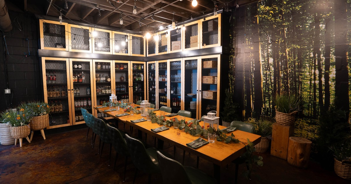 Cozy dining room with rustic wooden table set for a meal, surrounded by green chairs