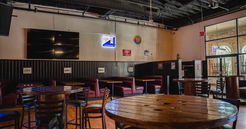 Interior, spacious dining area with high chairs and dining booths in the back