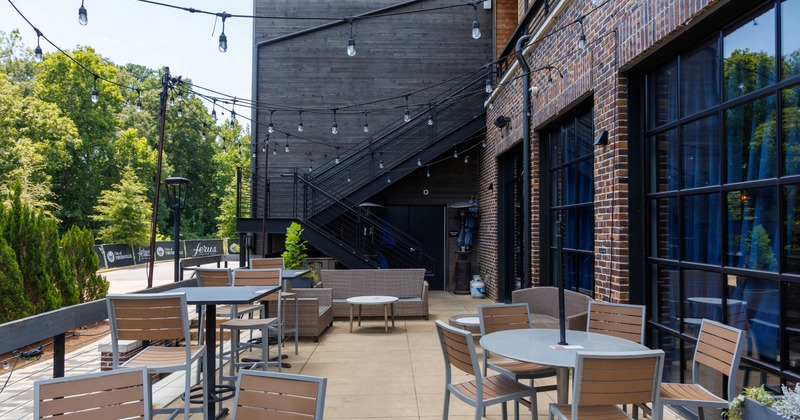 Outdoor, patio with tables, chairs and hanging string lights