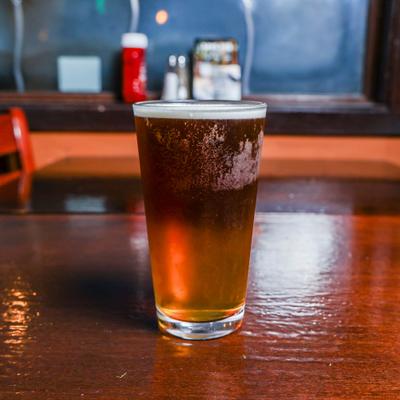 Cold amber beer on a wooden counter.
