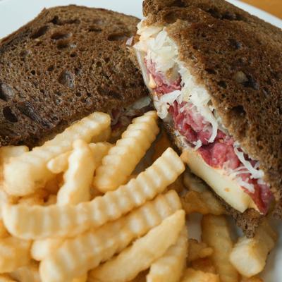 Grilled Reuben on dark rye, served with crinkle cut fries.