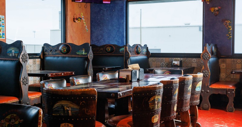 Dining area with tables and booths, TV on the wall