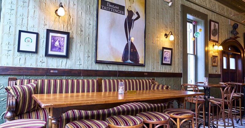 Inside, long table with chairs, paintings on the wall