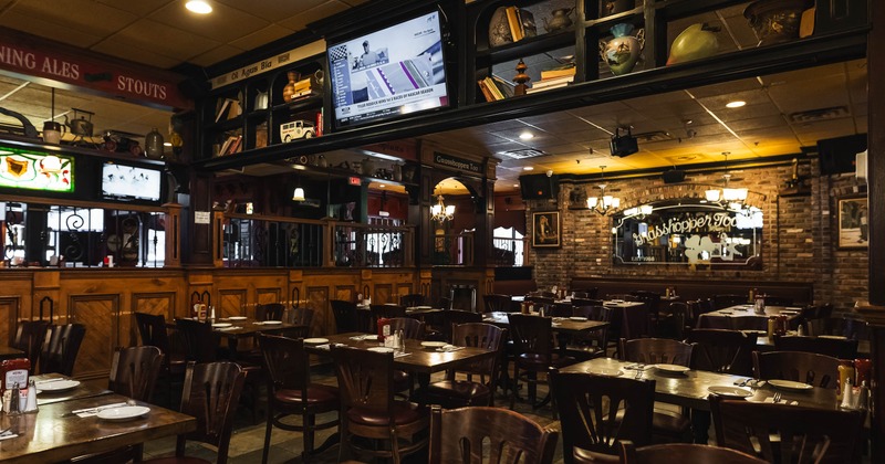 Cozy pub interior with wooden tables, chairs, and ambient lighting