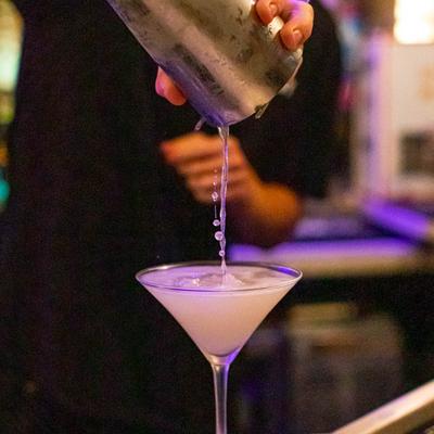 Bartender pouring a Martini.