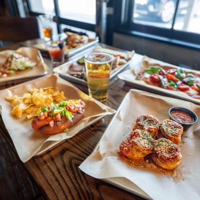 Assortment of food plates and drinks.