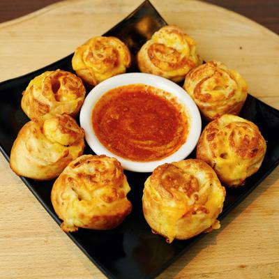 Pizza pinwheels served with marinara.