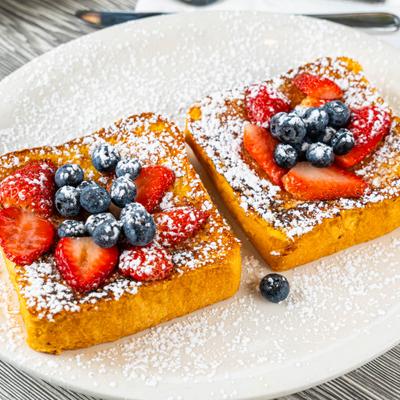 Canoli French Toast topped woth berries and powdered sugar.