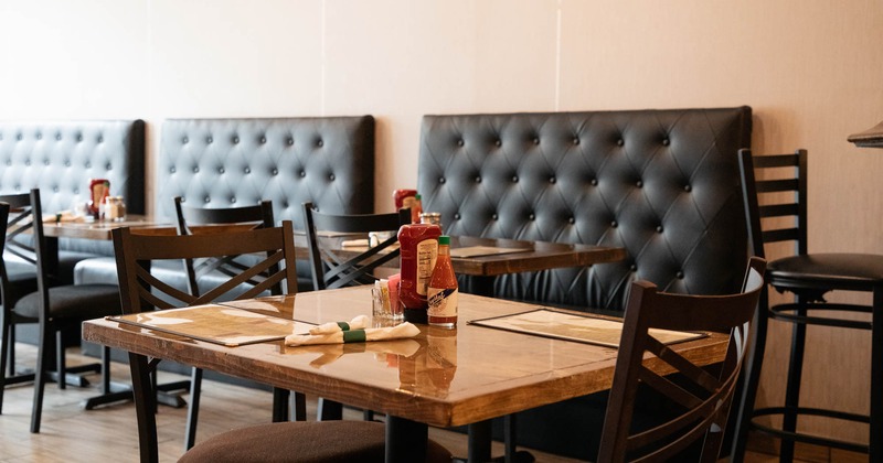 Close view of a table and chairs with booths in the back