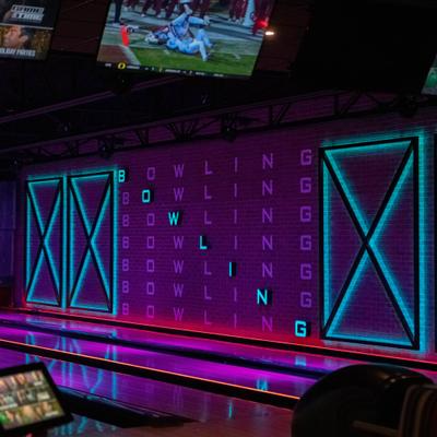 Neon lights and screens on the wall.