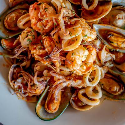 Seafood mix with shrimp, calamari, and mussels in a tomato-based sauce.