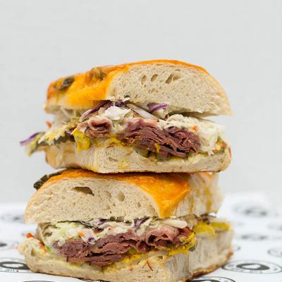 Sandwich with corned beef, pastrami, pickles, mustard, Swiss, and jalapeno coleslaw.