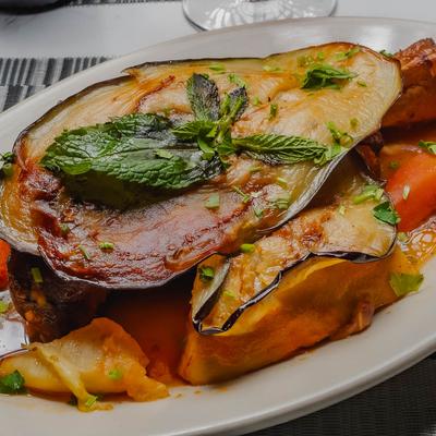 Lamb Shank, red sauce with eggplant, potato, carrot & rice.