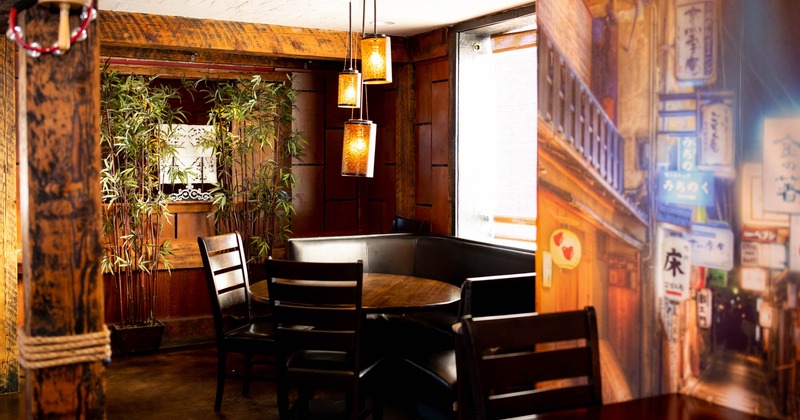 A corner booth with table and chairs