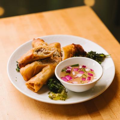 Spring rolls served with dipping sauce.