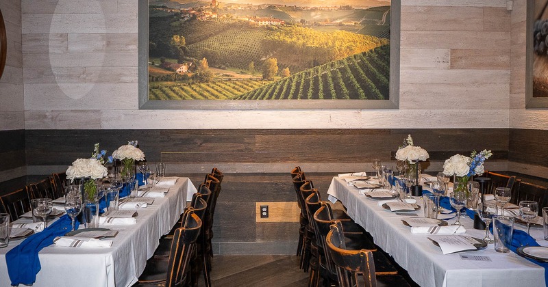 Interior, two big tables with tableware and glasses