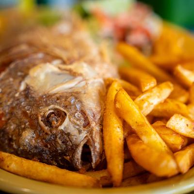 Fried whole fish with fries.