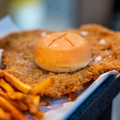 Pork loin sandwich served with fries.