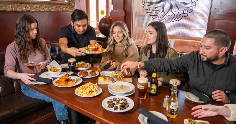 Customers sitting at a table full of food
