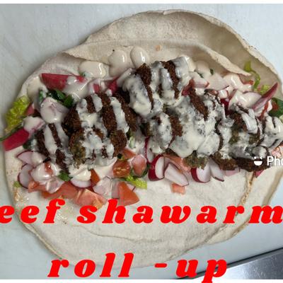 Beef Shawarma with onions, tomatoes, parsley, pickles and tahini sauce.