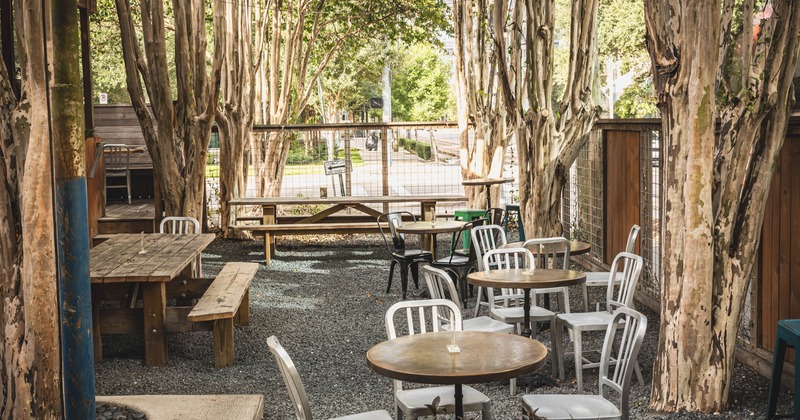 Outdoor seating area with wooden tables and benches