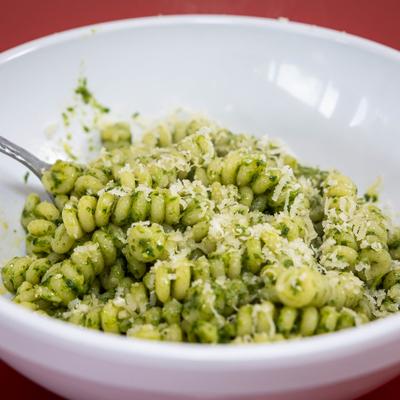 Pesto Fusilli topped with grated cheese.