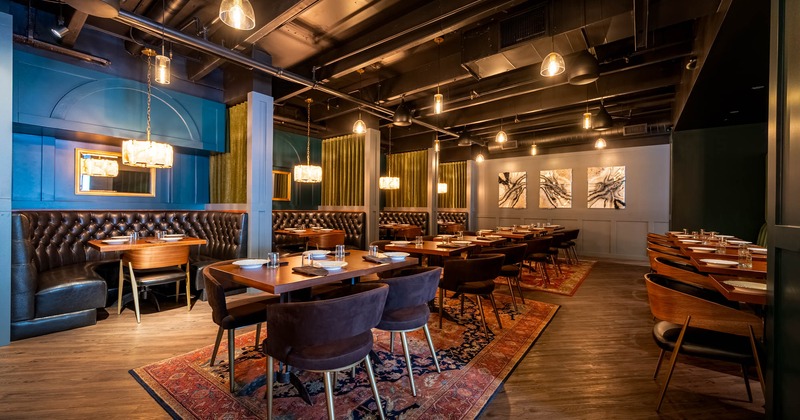 Interior, dining tables and half circle booths ready for guests