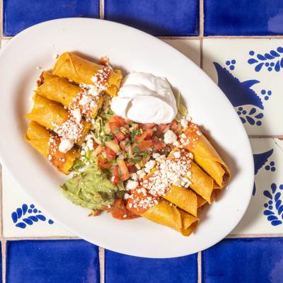 Chicken crispy corn tacos with cheese, guacamole, sour cream, pico de gallo.