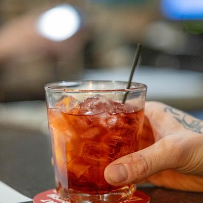 A hand holding a drink.