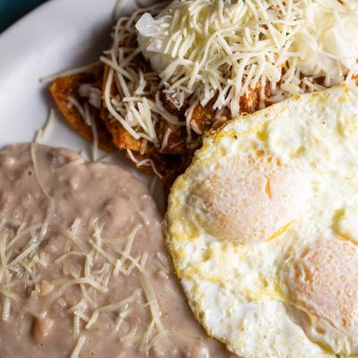 Fried eggs, with nachos and refried beans
