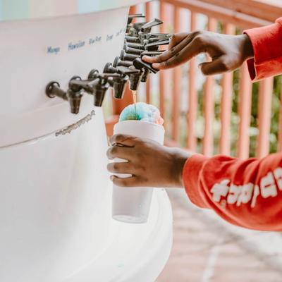 Hands pouring a drink from a dispensary.