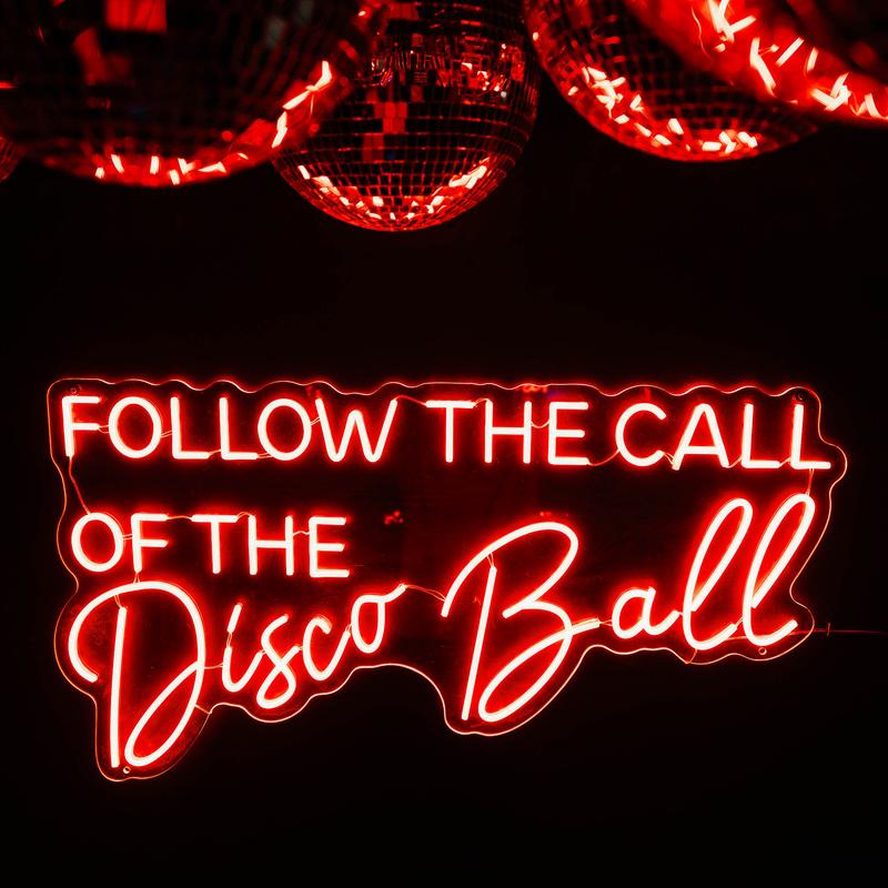 Neon sign in red glowing letters reads 