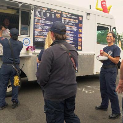 Customers waiting in line at a food truck.