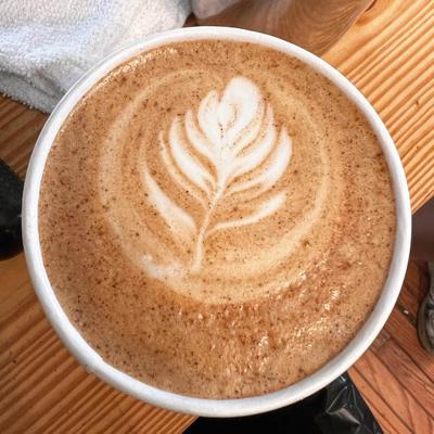 Latte with latte art on a table, top view.