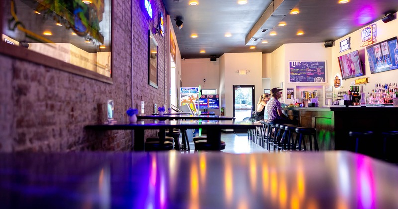 Interior, seating area, high seating tables, wooden top bar with stools, bar entrance