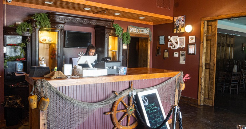 Interior, front desk counter with staff in action