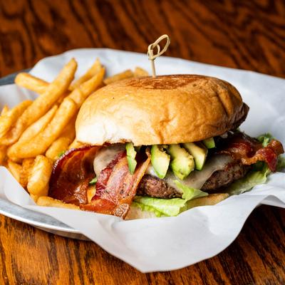 Bacon cheeseburger with avocado, lettuce, tomato, mayo, and fries.