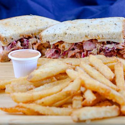 Rachel, corned beef sandwich, served with fries.